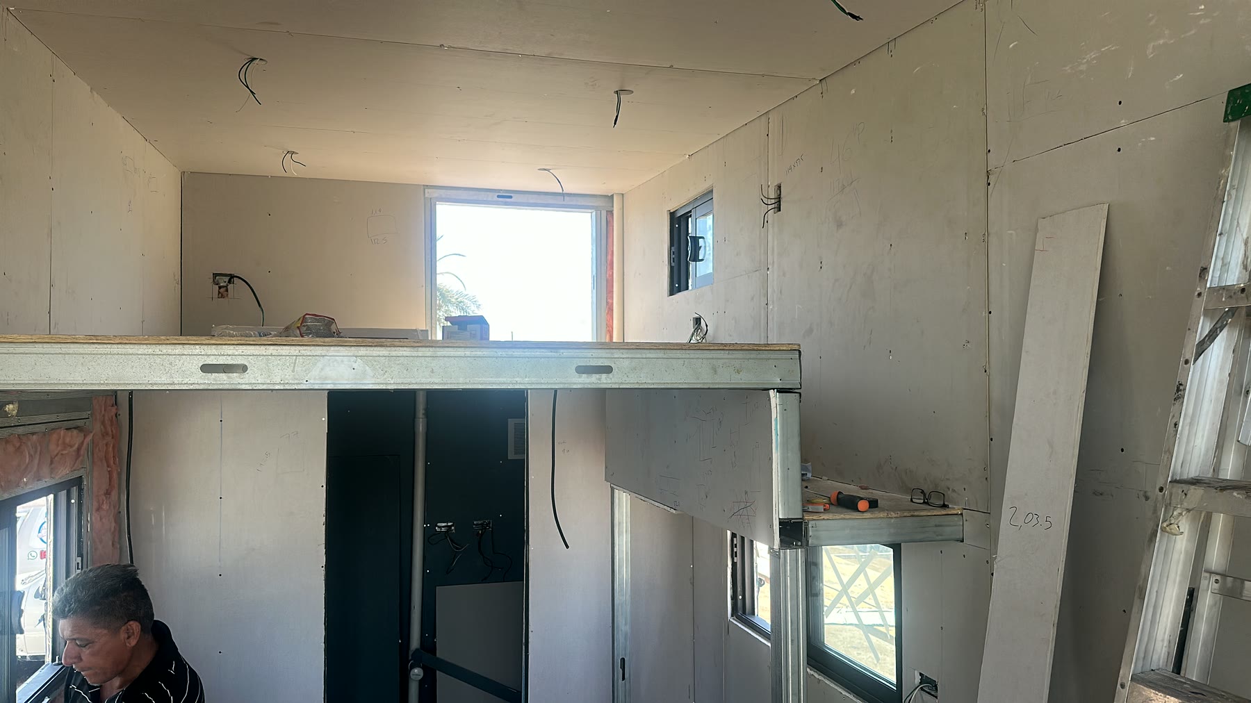 Rise20 interior with drywall installed around the loft and windows